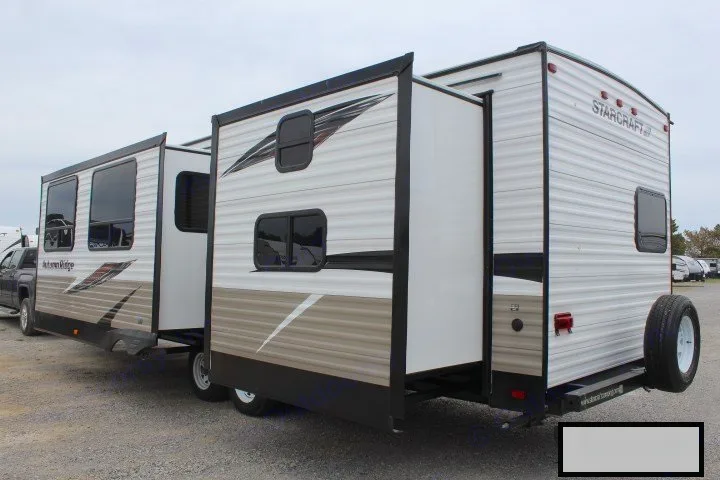Rear-angled view of a large Starcraft travel trailer with slide-outs extended, perfect for an RV rental.. Starcraft Autumn Ridge 2018