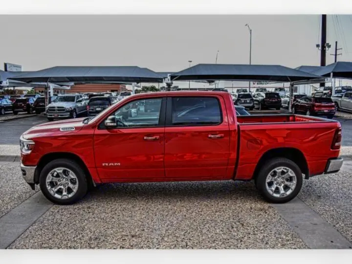 A shiny red pickup truck on a lot, ready to tow your RV rental. View diverse vehicles for your travel needs.. ram 1500 bighorn 2019