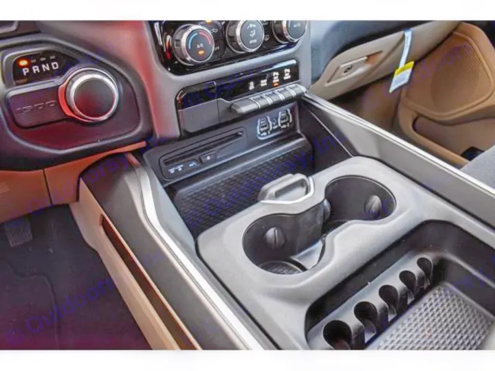 Detailed RV rental interior: rotary gear selector, console with dual cup holders, and accessible USB ports.. ram 1500 bighorn 2019