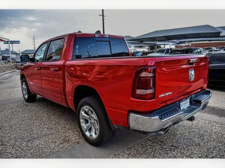 Bright red pickup truck, perfect for hauling gear or **RV rental** accessories. Browse our vehicle fleet!. ram 1500 bighorn 2019