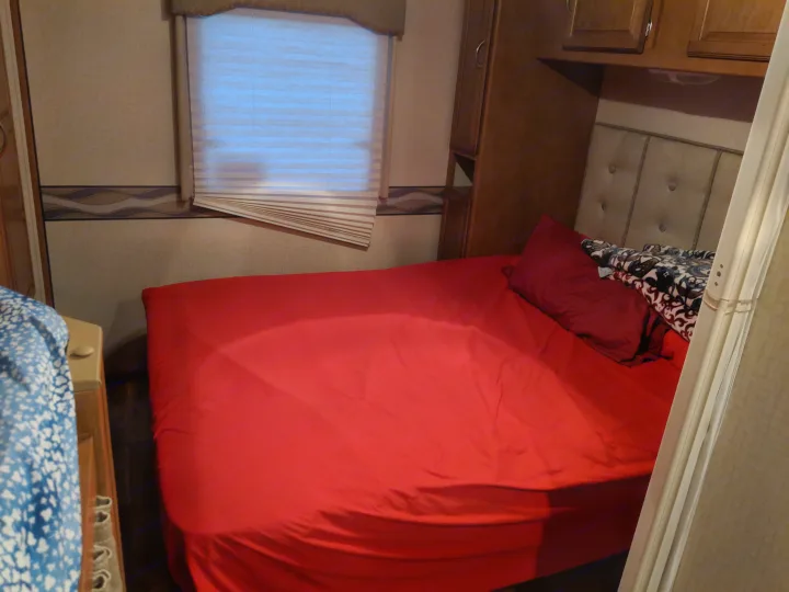 master bed and cabinets, slideout extended. comfortable queen-sized bed, plenty of cabinet space, screen for privacy  . Winnebago Minnie Winnie 2017