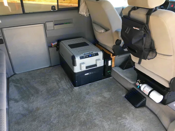 RV rental interior: A portable fridge, power inverter, and fire extinguisher offer amenities for comfortable camper van travel.. Volkswagen Westfalia 2002