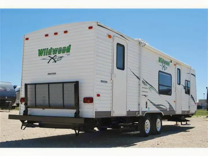Rear view showing backpack shelf perfect for carrying a generator, large ice chest, toolbox, or anything else you might need to carry that wont fit inside the trailer.. Forest River Wildwood X-Lite 2011