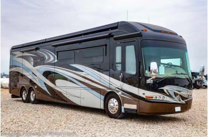 This grand black luxury RV, adorned with unique decals, stands on a gravel lot, available for rv rental.. Entegra Coach Anthem 44dlq 2016
