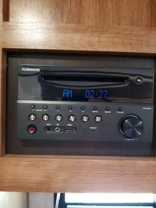 Furrion DV3300 entertainment system in an RV rental, displaying AM 02:27, with control panel, USB, and AUX inputs.. Jayco Jay Feather 2018