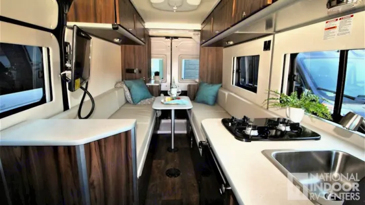 Spacious camper van rv rental interior with kitchen, dining area, and TV. Perfect for your next road trip adventure.. Hymer Carado Banff 2018