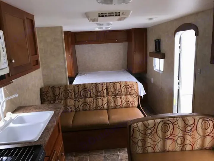 Spacious RV rental interior with full kitchen, comfortable bed, and dinette seating. Perfect for your next adventure!. Eclipse Recreational Vehicles Maveric 2011