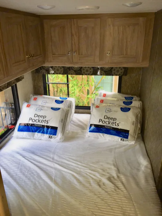 New Mainstays Deep Pockets pillows on a neatly made bed inside an RV rental, ready for guests.. ForestRiver Sunseeker 2018