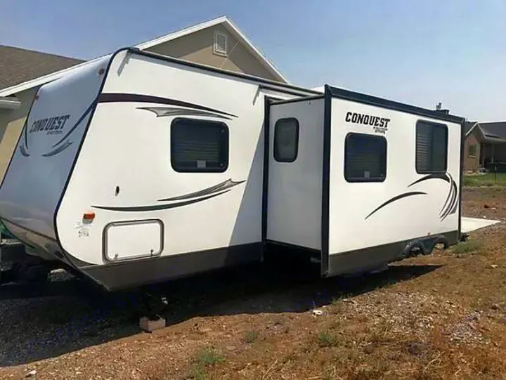 RV rental: A white Conquest travel trailer with an extended slide-out is shown, ready for your next adventure.. Gulf Stream Conquest 2014