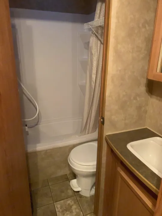 This RV rental features a practical bathroom with a compact shower, toilet, and sink area.. Jayco Jay Flight 2007