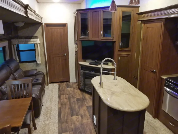 Experience comfort in this RV rental! Features a full kitchen island, recliners, entertainment center, and stylish wood-look floors.. Forest River Sierra 2018
