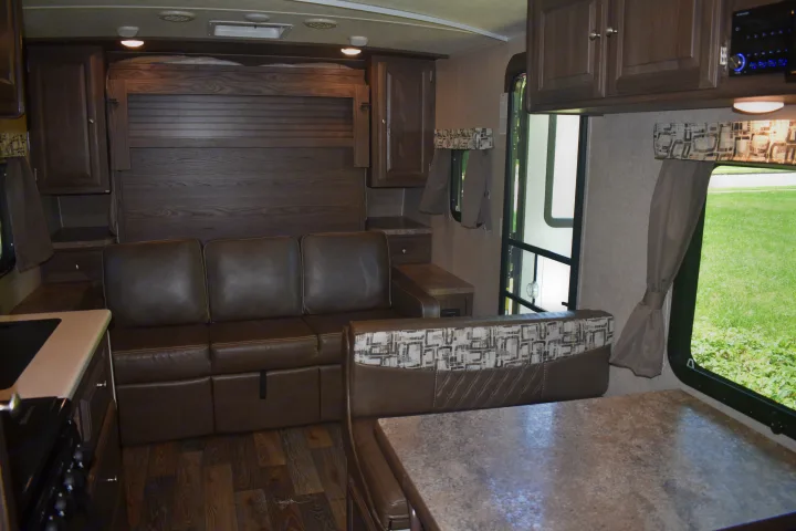 Spacious RV rental interior featuring a convertible sofa/Murphy bed, dinette, and kitchen for comfortable travel living.. Forest River Rockwood Mini Lite 2017