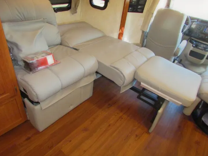 Comfortable RV rental interior with versatile seating that converts to a bed and includes an ottoman.. Phoenix USA Cruiser 2552 2011