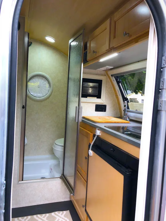 RV rental: Bright, compact camper interior featuring a kitchenette, wet bath with shower/toilet, & overhead storage.. T@B Other 2019