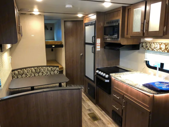 Dining room and kitchen (table converts to a bed). Keystone Hideout 2019
