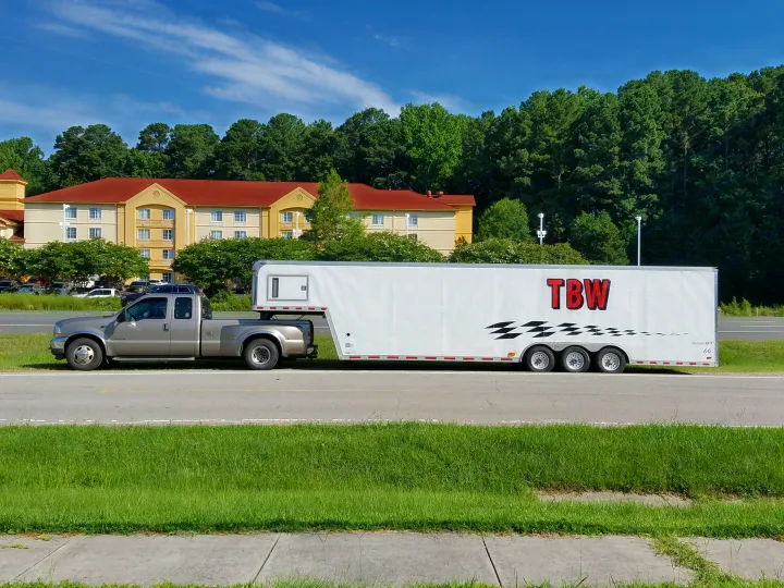 It's a 36 foot goose neck race car hauler..  :-) . Empty inside.
All six trailer wheels have electric brakes.. Pace American Shadow GT 2006