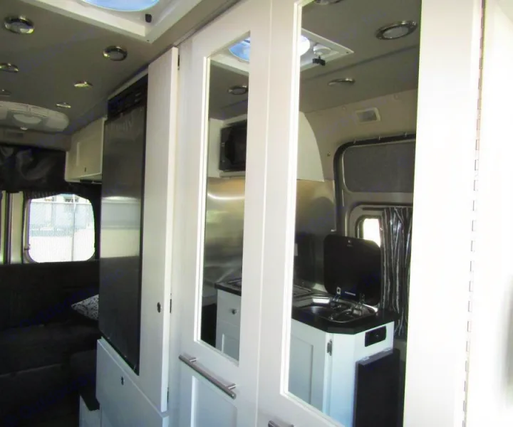 Enclosed bathroom w/ sink and shower with instant hot water. Keep your groceries fresh in your 5 cu. ft. refrigerator.  . Roadtrek Zion SRT 2019