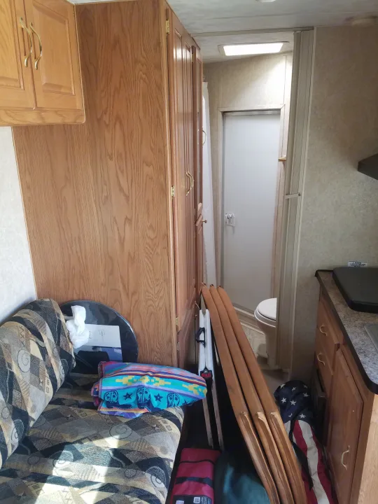 This is a look from the bed back. Refrigerator is to the right. Couch folds to a bed.  Micro is above the sink.. circle j riata 2005