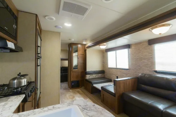 Spacious RV rental interior featuring a full kitchen, dining area, and comfortable living space for your travels.. Gulf Stream Kingsport 2019