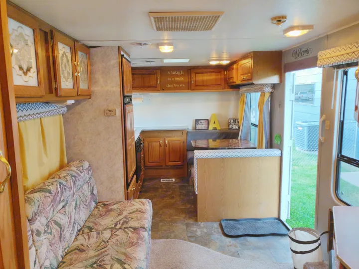 Right side of Camper when entering. Table converts to bed, sink, refrigerator and freezer, stove, oven, and LOTS of storage!. Jayco Eagle M 242 FK 1998
