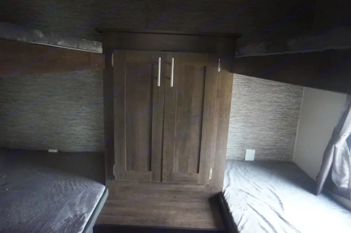 RV rental with cozy bunk beds and central storage cabinet, providing comfortable sleeping space.. K-Z Manufacturing sportsmen 301 2020