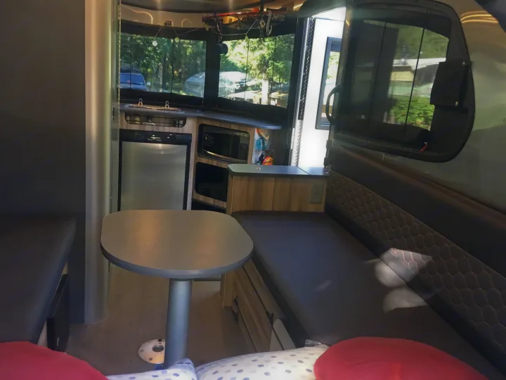 RV rental interior: functional kitchen, dinette, and scenic windows offer comfortable living on the road.. Airstream Base Camp 2017