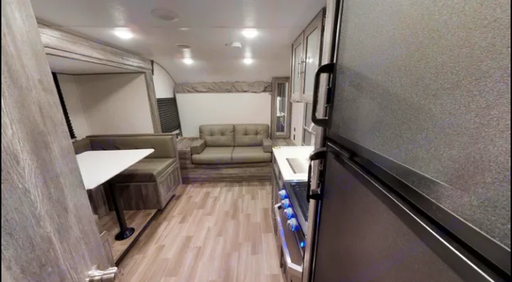 Main area both kitchen table and couch fold into beds. Forest River Wildwood 2020