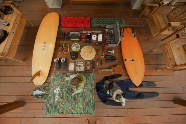 Packing for an RV rental family surf & camping trip: boards, gear, dog, and child's essentials are laid out.. Gear Rentals 2020