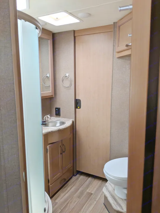 RV rental bathroom with shower, vanity, toilet, and modern finishes for a comfortable journey.. Thor Motor Coach A.C.E 2019