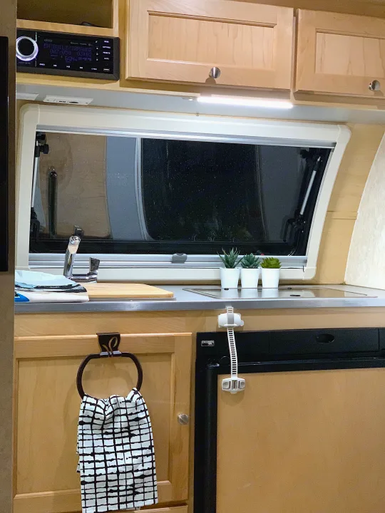 Functional RV rental interior: galley kitchen with sink, Norcold fridge, storage, and a multi-media stereo.. T@B Other 2019