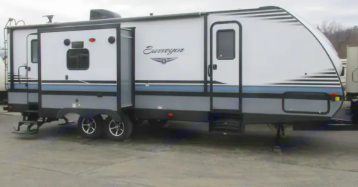 White and gray travel trailer with an extended slide-out, perfect for an RV rental vacation.. Forest River Surveyor 2018