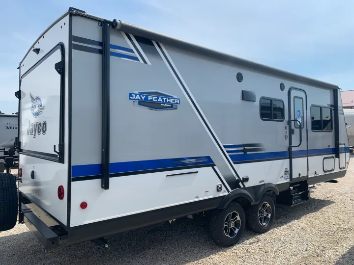 This Jayco Jay Feather travel trailer, ideal for RV rental, showcases a modern gray and white exterior with a large awning.. Jayco Jay Feather 2019