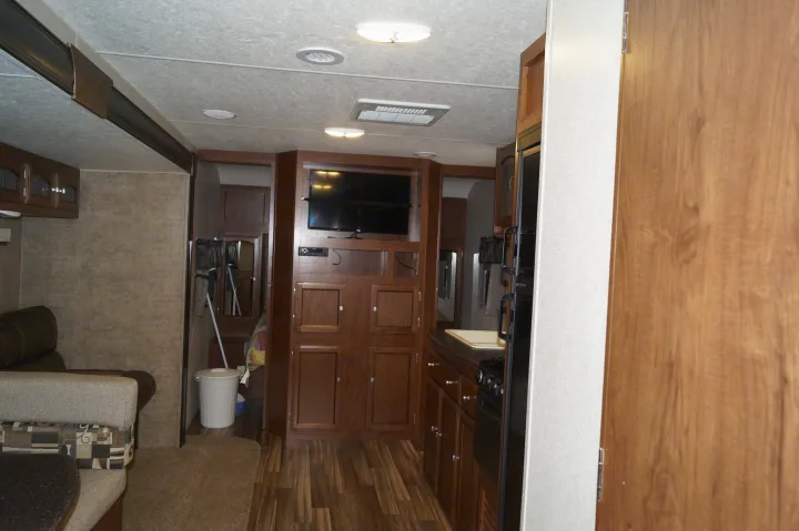 Spacious RV rental interior with a cozy living area, full kitchen, and entertainment center.. Coachmen Freedom Express 2017