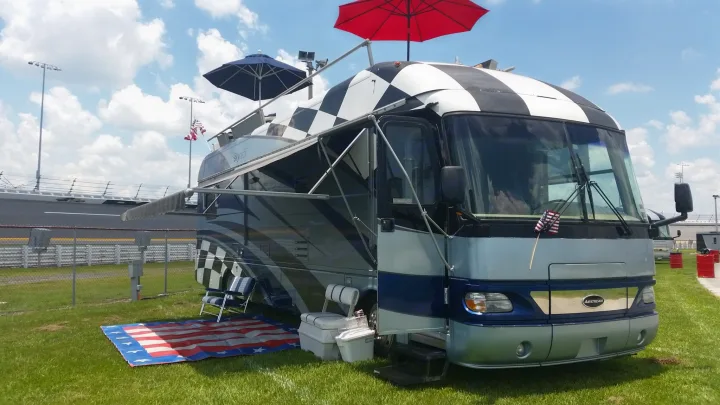 Checkered RV rental with viewing deck & patriotic mat at a racetrack. Perfect for race day tailgating!. Airstream Skydeck 2008