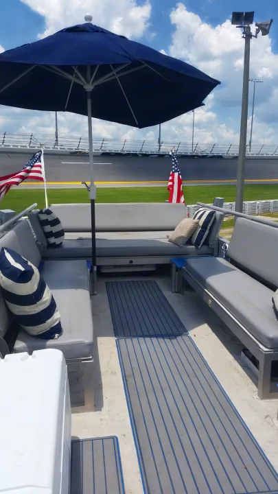 Luxury RV rental offers a comfortable, shaded viewing deck with American flags overlooking a race track.. Airstream Skydeck 2008