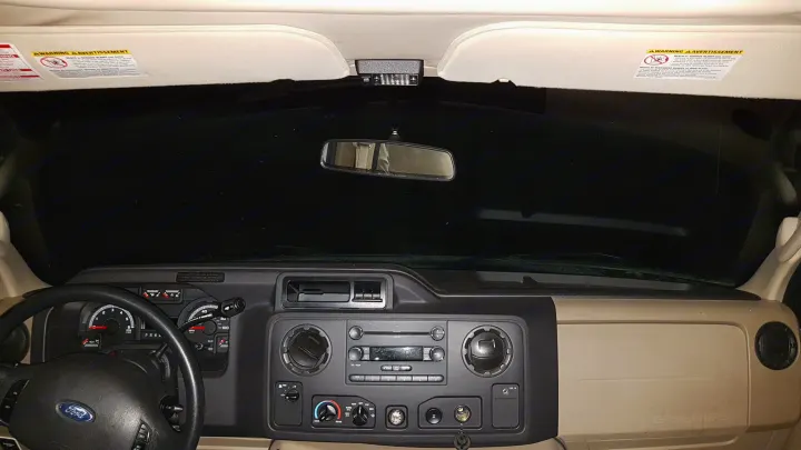 Inside an RV rental, showing the Ford dashboard, steering wheel, and windshield view at night from the driver's seat.. Majestic Leisure Craft 28A 2013