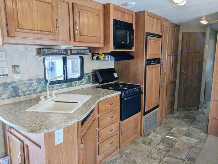 Full kitchen with plenty of storage. Gas oven has never been used. . Jayco Jay Flight 2009