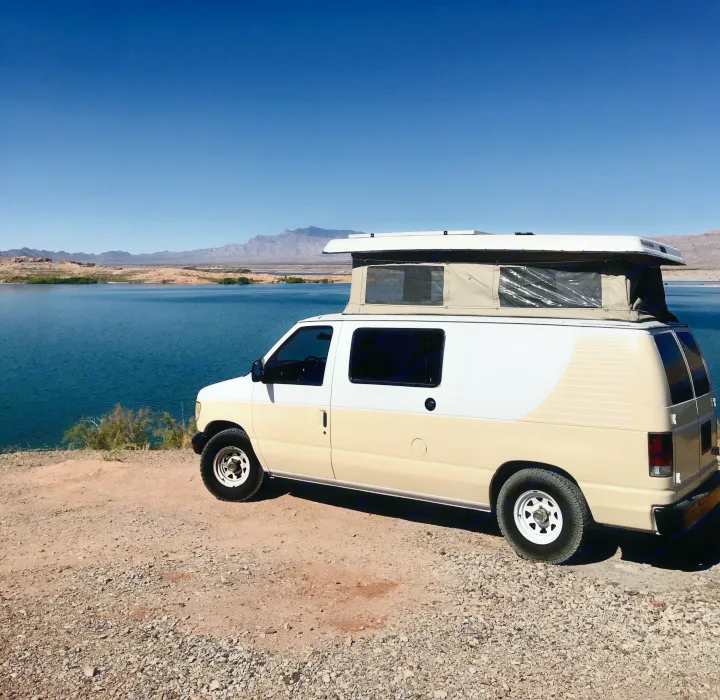 Loft apartment on wheels with fake wood floors and a view of whatever you are parked by. . Sportsmobile Ford Campervan 1995