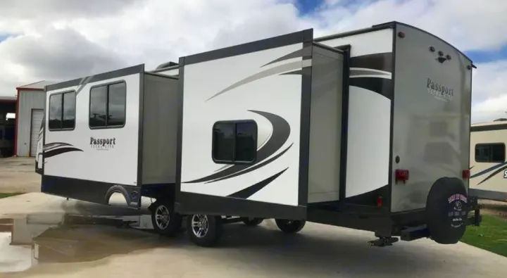 RV rental: A white and gray Passport travel trailer with extended slide-outs, offering spacious living and comfort.. Keystone Passport 2019