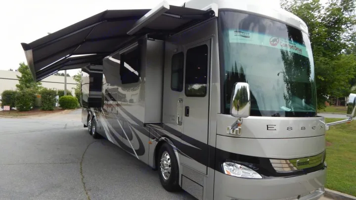 This spacious, light gray Newmar Essex motorhome RV rental has an extended awning.. Newmar Essex 2018