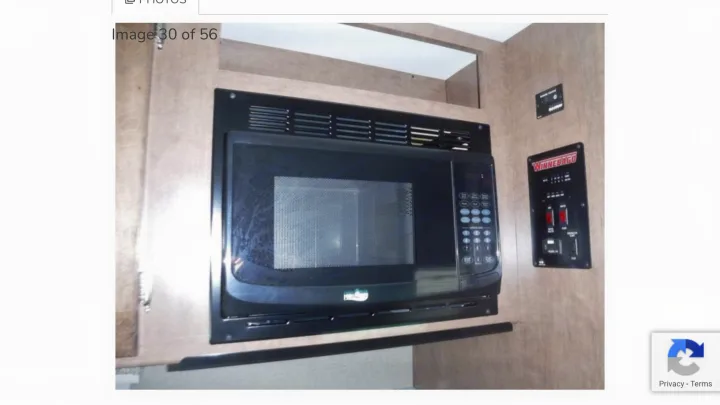 Built-in microwave and Winnebago control panel in this RV rental's kitchen area.. Winnebago Outlook 2019