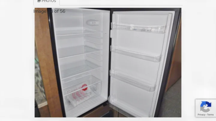 RV rental: Open refrigerator with clear shelves and door storage. This clean, compact unit is ready for your trip.. Winnebago Outlook 2019