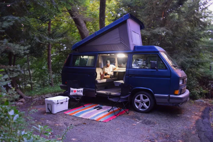 The couch Jeff is relaxing on pulls down into a bed. The second bed is in the loft above his head. Volkswagen Westfalia 1990