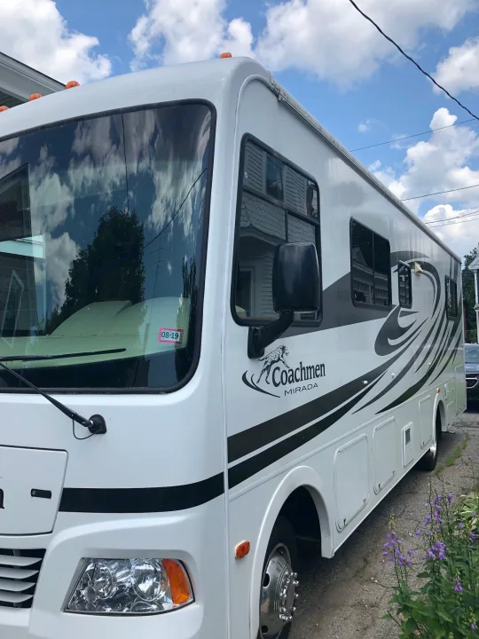 White Coachmen Mirada RV showcasing black decals, ideal for rv rental.. Ford Coachman 2009