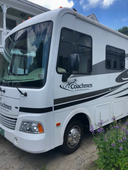 White Coachmen Mirada motorhome, perfect for an RV rental adventure, parked on a sunny day.. Ford Coachman 2009