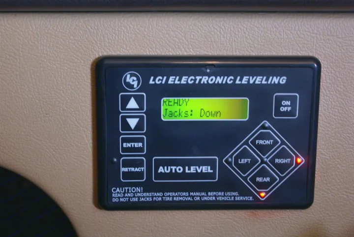 RV rental LCI electronic leveling system control panel displaying "READY Jacks: Down.". Winnebago Vista 2013