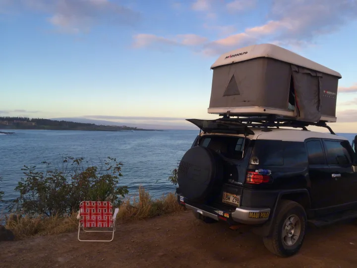Easy to store surfboard and travel gear.  Room top is solid quality for all weather and easy to pop up, you don't need even surface to swing a tent to be secure, this tent pops up vertical. Toyota FJ Cruiser 2008