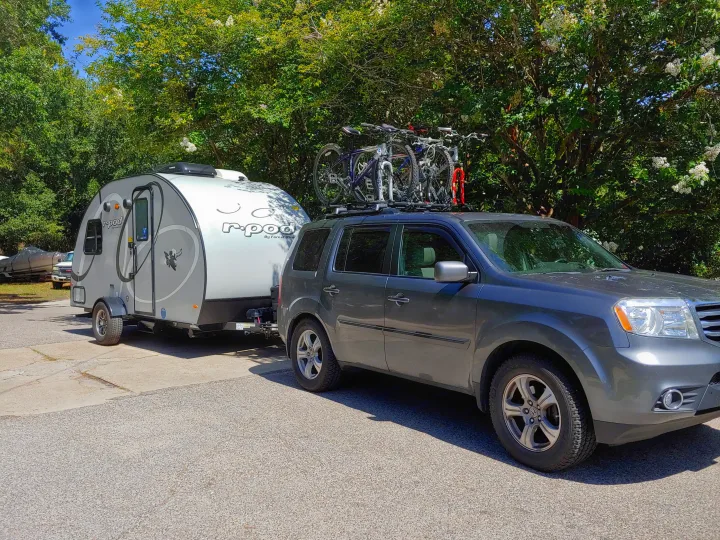 The pod on the go!  As a family of 4, we put 3 bikes on our car and one inside on a bunk.  The other side has a handy outdoor shower.. Forest River Other 2020