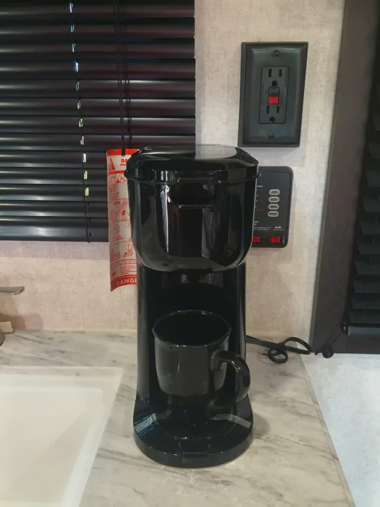 An RV rental interior features a coffee maker, GFI outlet, and control panel with tank and battery monitors.. Jayco Jay Flight SLX 2019