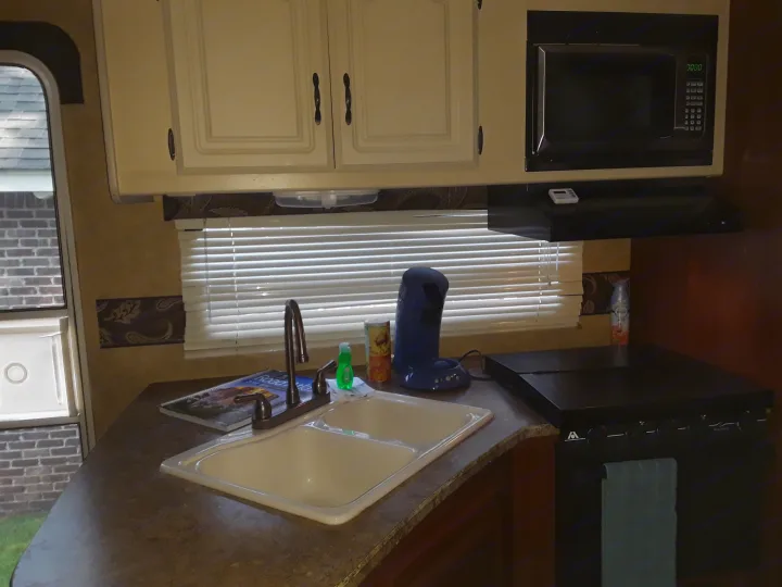 Double sink with cutting board cover, stove with cover and vent, new microwave, oven and senseo pad coffee maker at your disposal  - cook away!. Keystone Outback BH312 2011